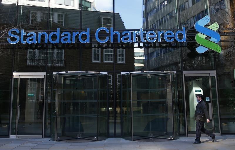 A man walks past the head office of Standard Chartered bank in the City of London February 27, 2015.(Reuters)