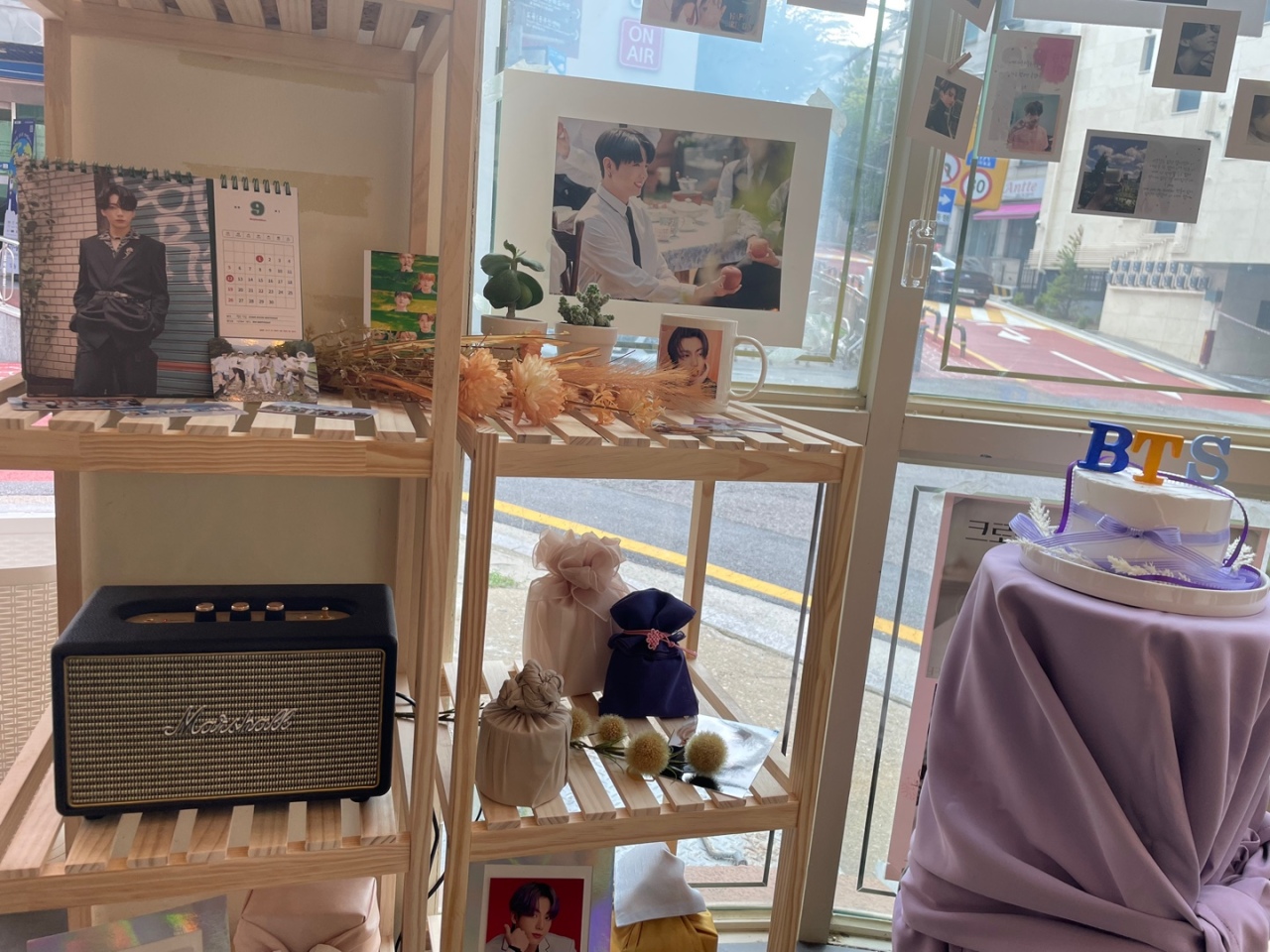 K-pop birthday cafe and cup sleeve event in Seoul with idol photos, decorations, and custom-made cup holders prepared by fans for fellow K-pop devotees