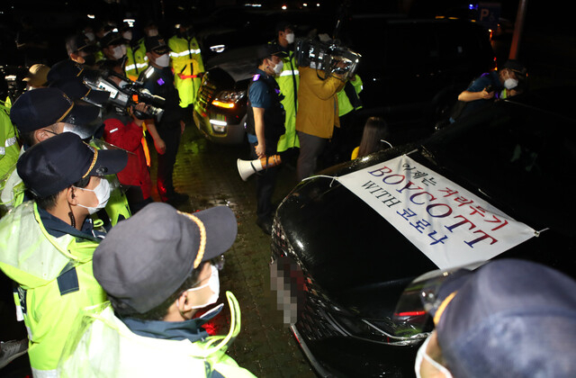 25일 오후 부산 사상구 삼락생태공원 주차장에서 차량시위를 앞둔 자영업자가 탄 차가 경찰과 대치하고 있다. [연합]