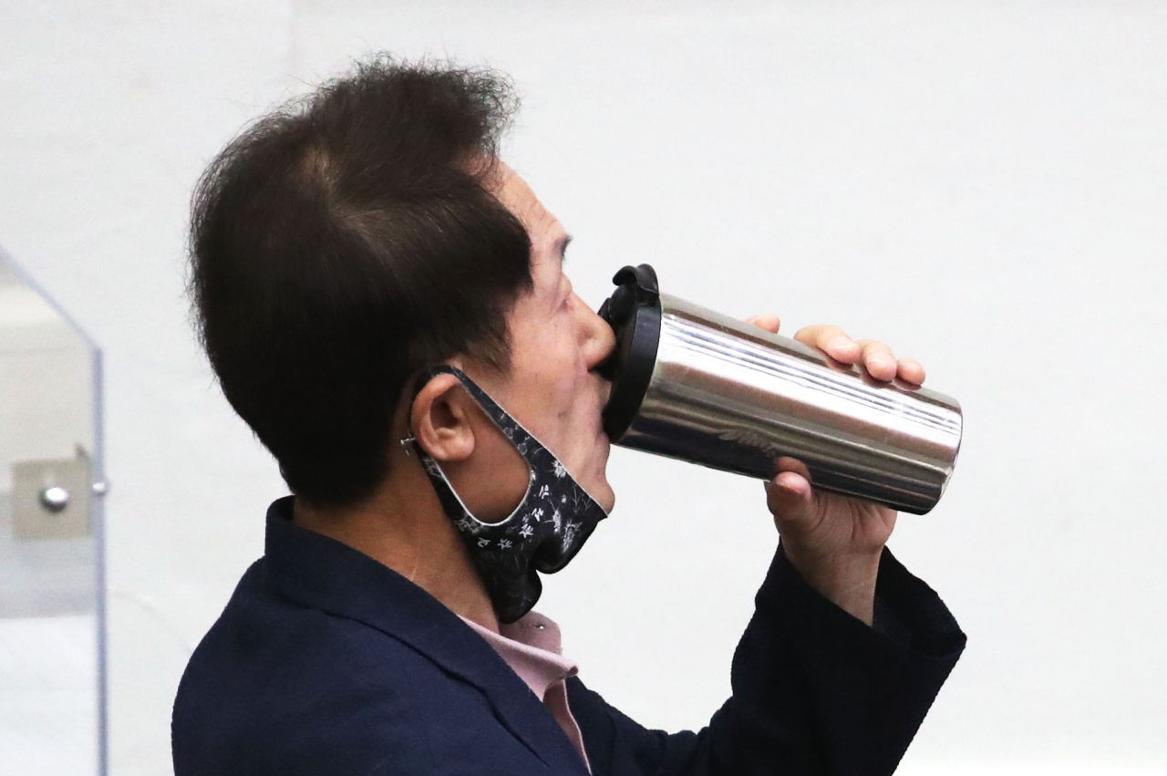 조희연 서울시교육감이 3일 오전 서울 중구 서울시의회에서 열린 본회의에 출석, 목을 축이고 있다. 이날 고위공직자범죄수사처는 조 교육감의 해직교사 불법 특별채용 관련 혐의가 인정된다며 검찰에 기소를 요구했다. [연합]