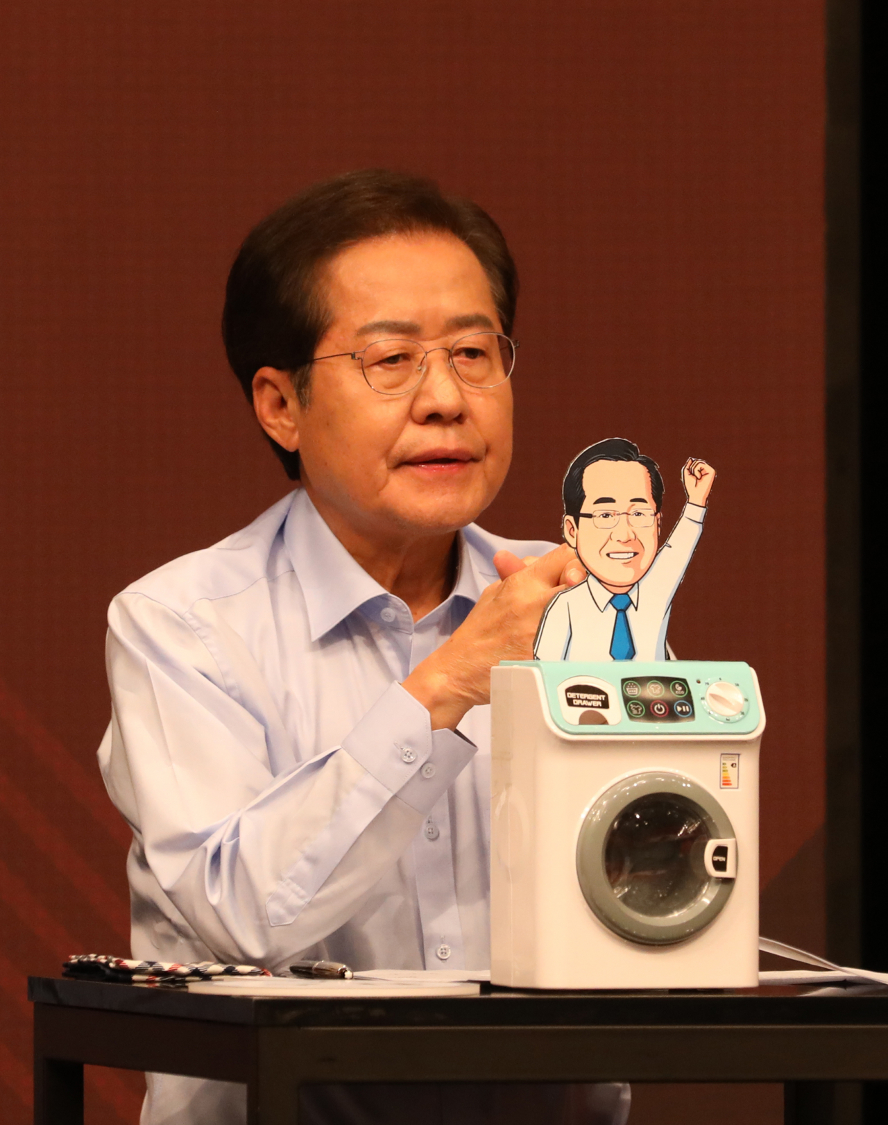 홍준표 국민의힘 대선 경선 후보가 26일 서울 마포구 상암동 채널A 스튜디오에서 열린 국민의힘 제20대 대통령 경선후보 3차 방송토론회에서 준비한 '세탁기' 모형을 보여주고 있다. [연합]