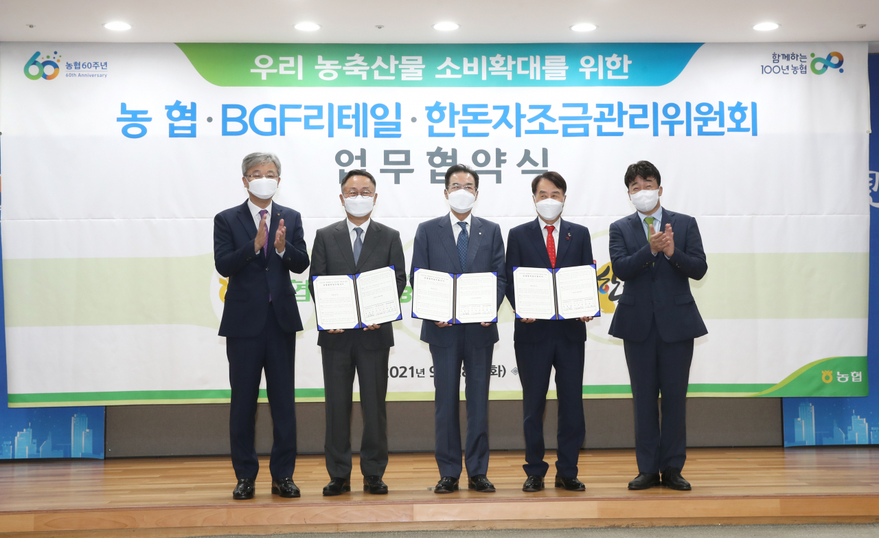 이성희(가운데) 농협중앙회장이 29일 서울 중구 농협중앙회 본관에서 진행된 BGF리테일·한돈자조금과 업무협약 체결식에서 기념촬영을 하고 있다.[농협 제공]