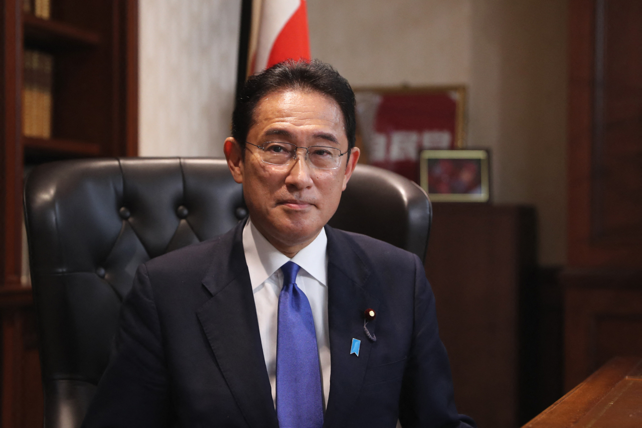 기시다 후미오(岸田文雄·가운데) 전 자민당 정무조사회장이 지난 29일 일본 집권 자민당 총재로 선출된 후 도쿄(東京)에 위치한 자민당 중앙 당사 총재석에 앉아 기념 촬영을 하고 있다. [AFP]