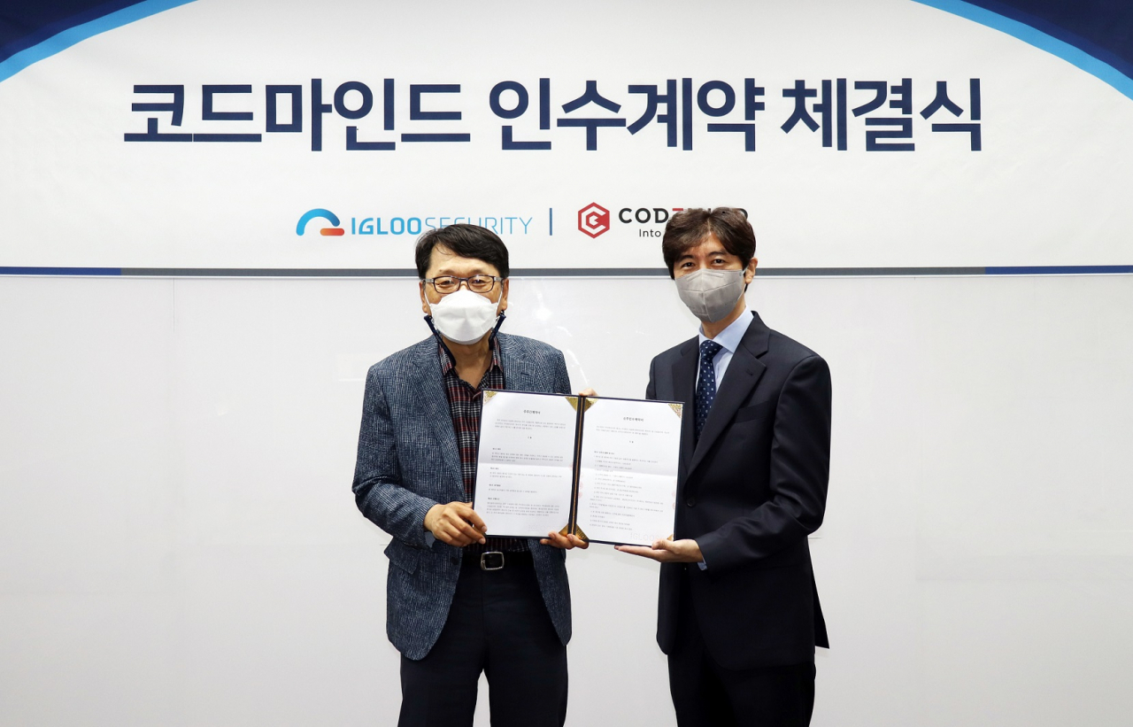 이득춘 이글루시큐리티 대표(왼쪽)와 신승철 코드마인드 대표가 서울시 송파구 문정동 이글루시큐리티 본사에서 인수 계약 체결을 맺고 기념촬영을 하고 있다. [이글루시큐리티 제공]