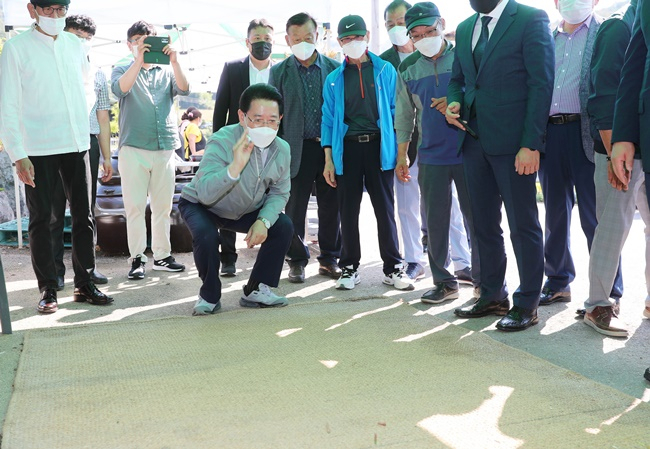 김영록 전남지사가 9일 순천 문성마을 축제에 참가해 덕석(멍석) 위에 새겨진 윷판에 종지기윷(작은그릇에 담아 던지는 윷놀이)을 던져보고 있다. [전남도 제공]