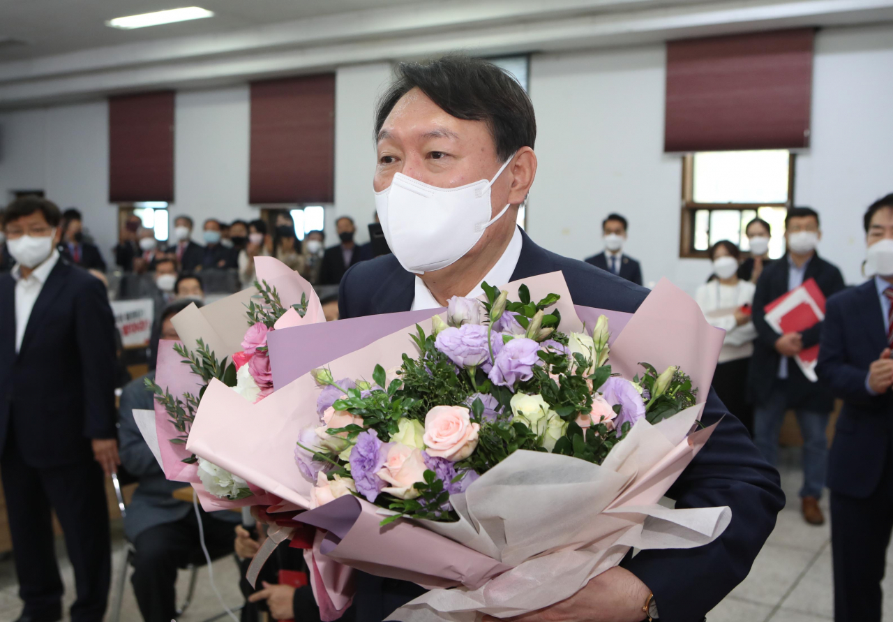 국민의힘 대권주자인 윤석열 전 검찰총장이 20일 대구시당에서 열린 국민캠프 대구 선대위 임명장 수여식에서 지지자들로부터가 꽃다발을 받고 있다. [연합]