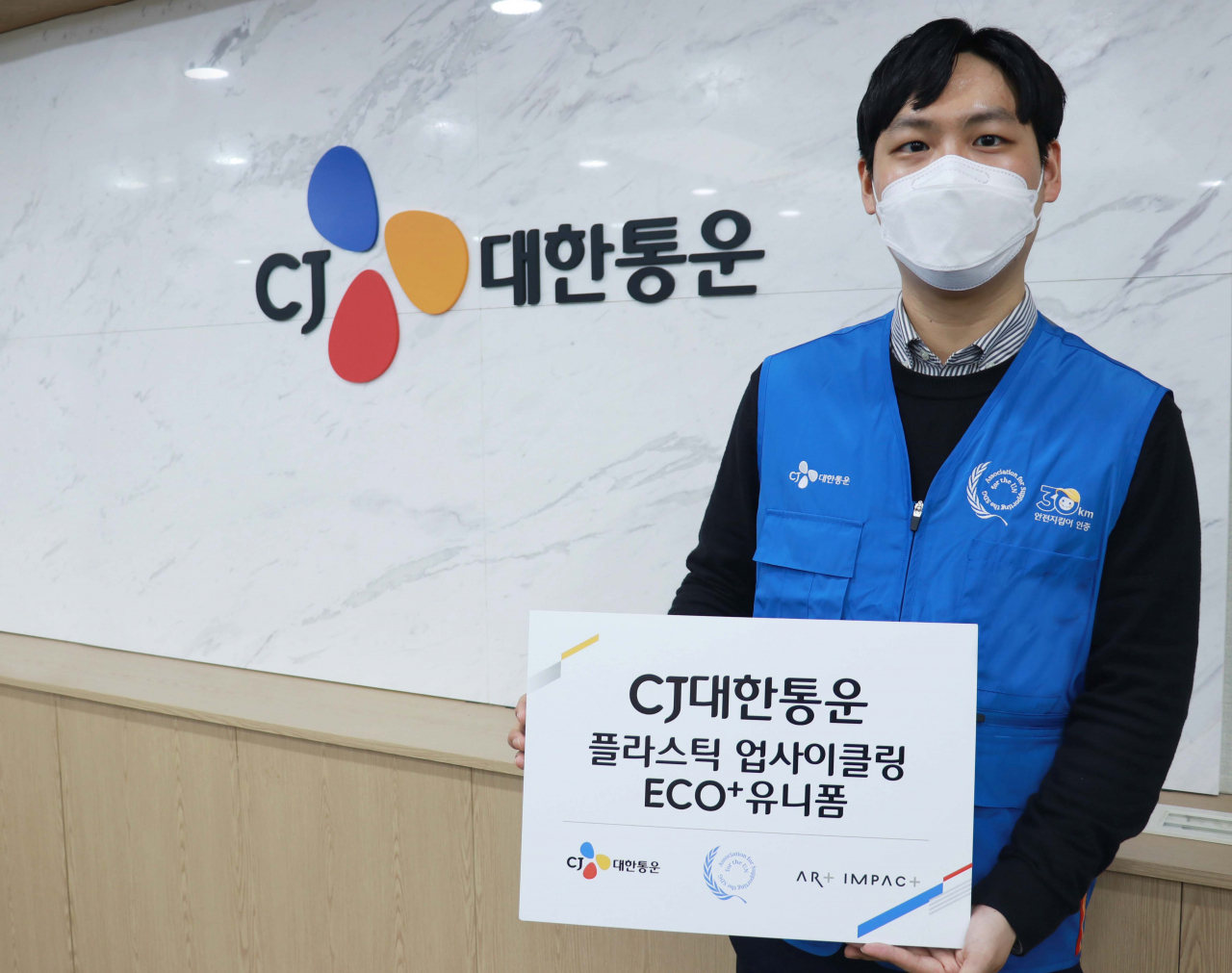 CJ대한통운 직원이 폐플라스틱 업사이클링 통해 제작한 ‘ECO+ 유니폼’을 입고 기념 촬영하고 있다. [CJ대한통운 제공]