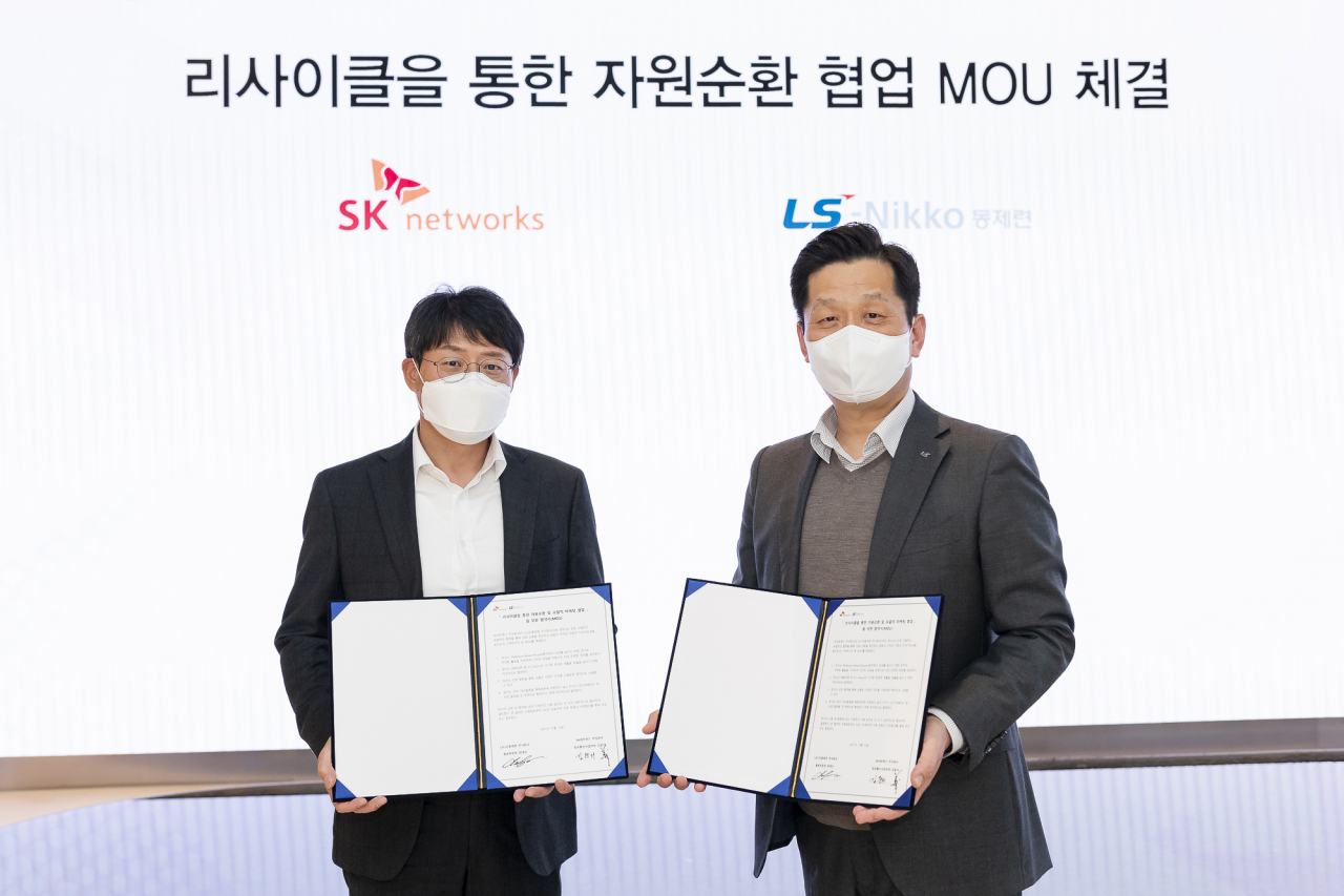 SK네트웍스와 LS니꼬동제련이 ‘리사이클을 통한 자원순환 및 포괄적 마케팅 협업’ 양해각서를 체결했다. 15일 협약식을 마친 후 김윤의 SK네트웍스 정보통신사업부장(왼쪽)과 최태선 LS니꼬동제련 원료부문장이 기념촬영을 하고 있다.[SK네트웍스 제공]