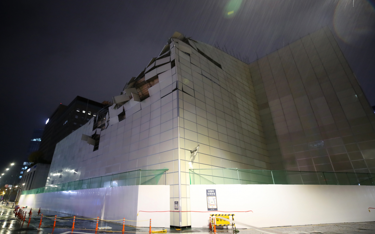 지난 21일] 밤 소방합동청사 건립을 위한 철거 작업이 진행되고 있는 서울 종로구 옛 종로소방서 철거현장 외벽가림막이 강한 비바람에 파손돼 있다. [연합]