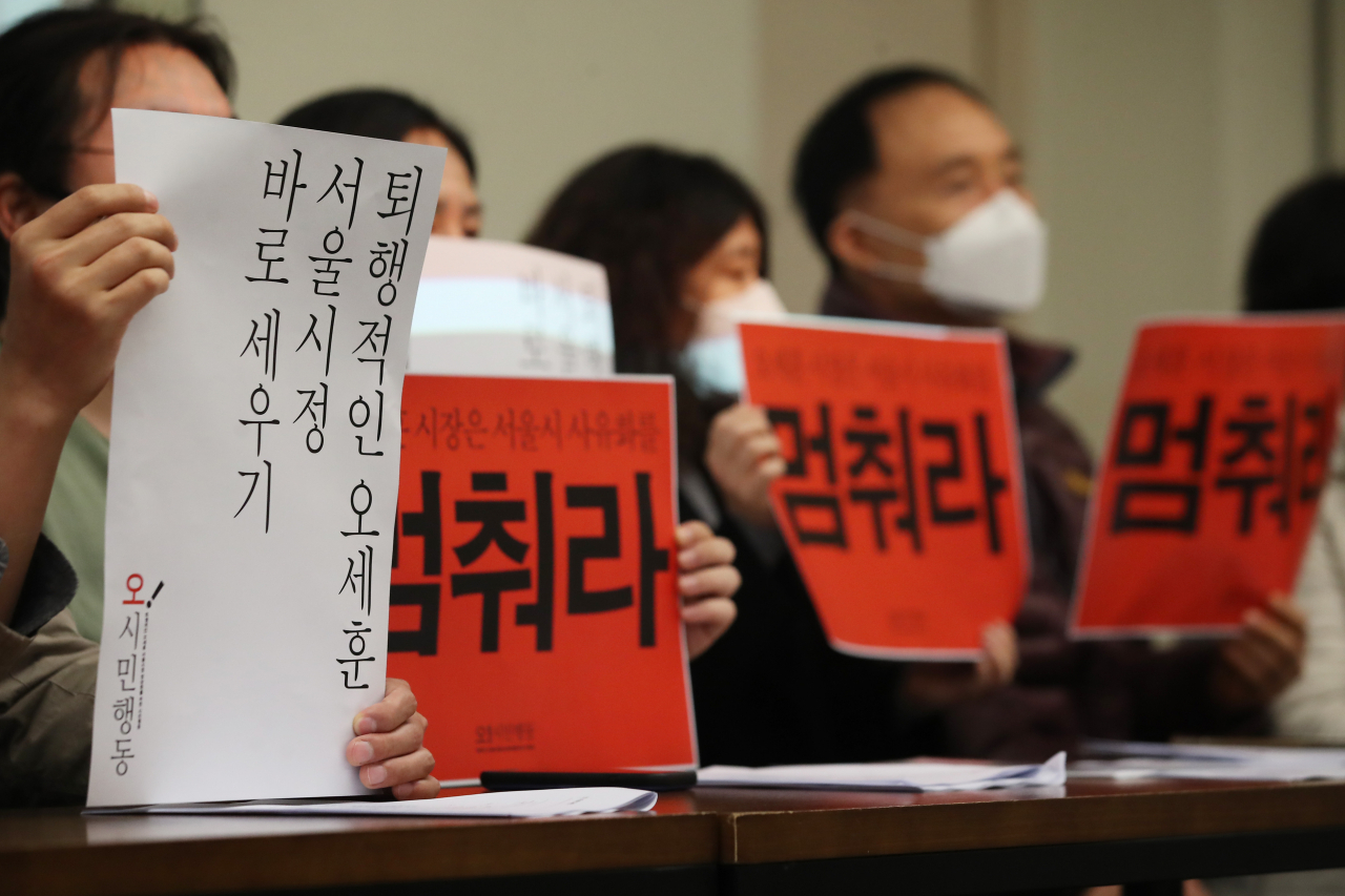 30일 오전 서울 중구 정동 프란체스코회관에서 열린 ‘퇴행적인 오세훈 서울시정 정상화를 위한 시민행동 발족행사’에서 참석자들이 손팻말을 들고 있다. [연합]