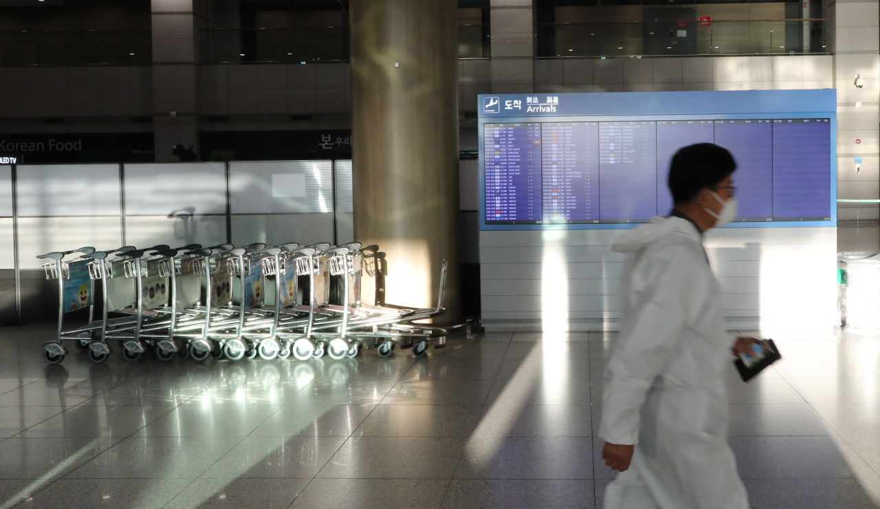This photo taken Wednesday shows an Incheon Airport official dressed in protective gear. (Yonhap)
