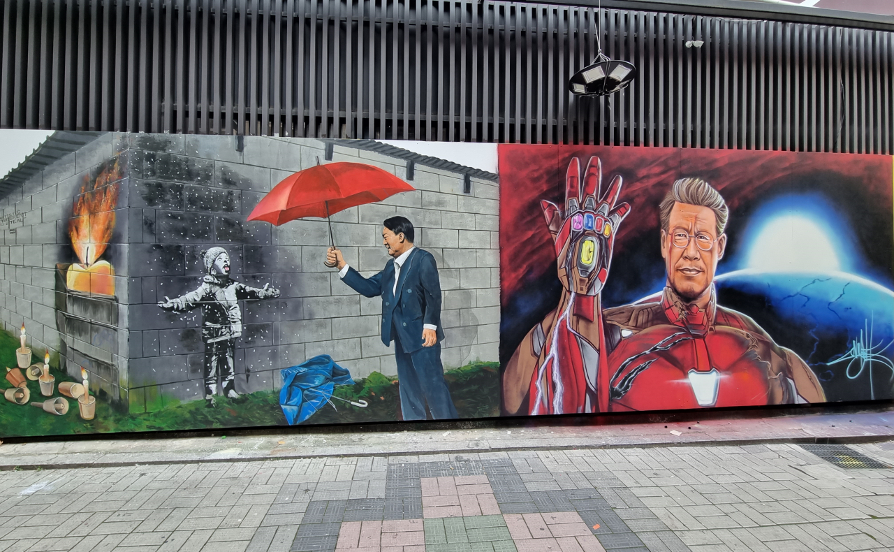 지난 7일 오후 서울 종로구 관철동 홍길동 중고서점 외벽에 이재명 더불어민주당 대선후보와 윤석열 국민의힘 대선후보를 빗댄 그림이 그려져 있다. 김영철 기자