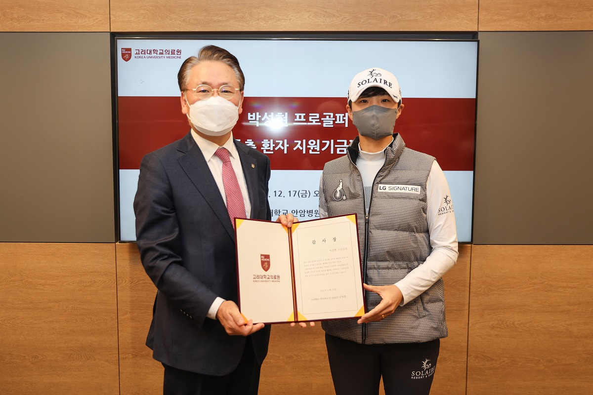 고려대 김영훈 의무부총장(좌)과 박성현 프로(우)가 기부식에서 기념촬영을 하고 있다
