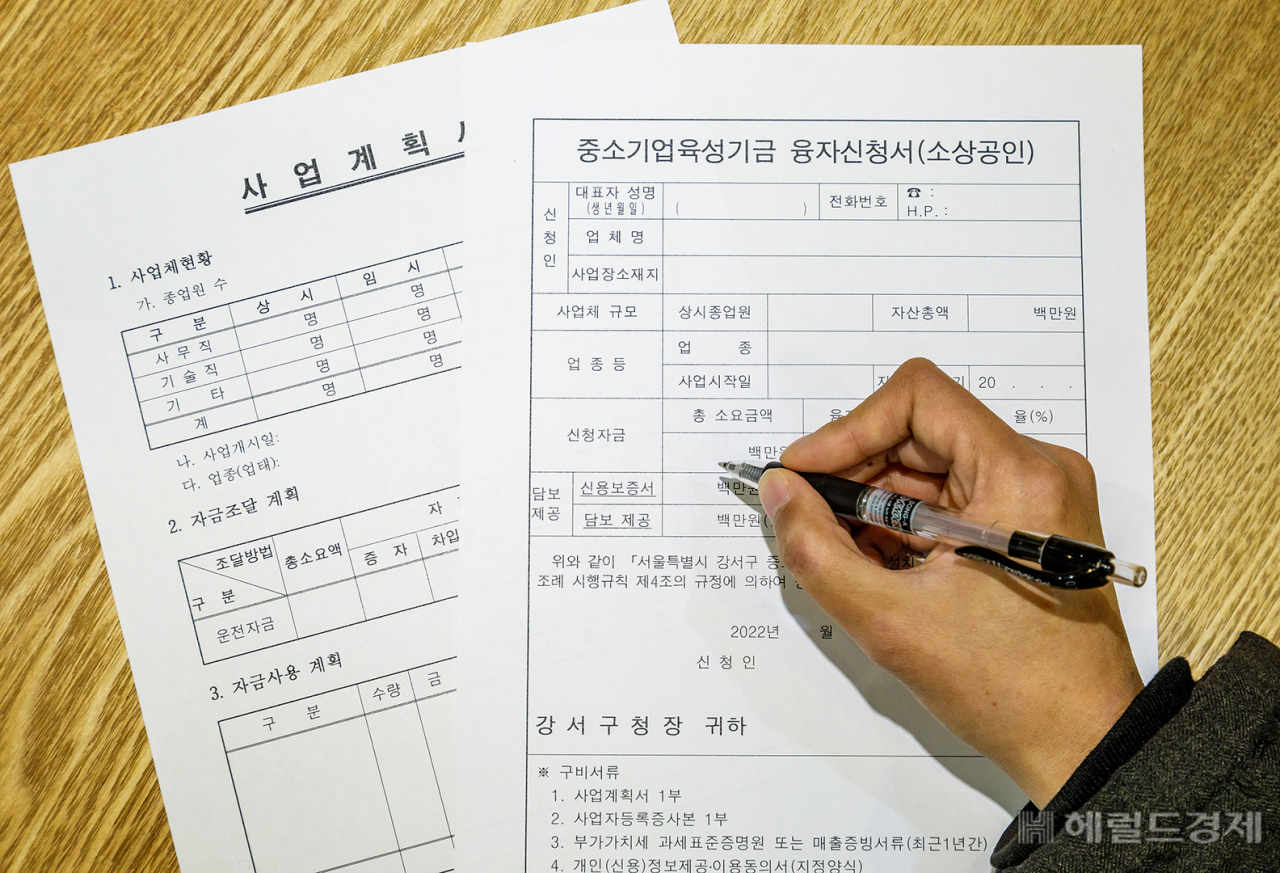 한 소상공인이 중소기업 육성자금 신청서를 작성하고 있다. [강서구]