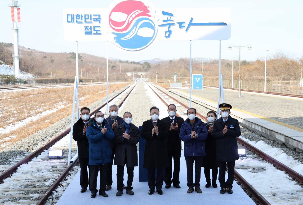 문재인 대통령이 5일 오전 강원 고성군 제진역에서 열린 동해선 강릉~제진 철도건설 착공식이 끝난 뒤 서명판에 서명한 뒤 참석자들과 기념촬영을 하고 있다. 연합뉴스