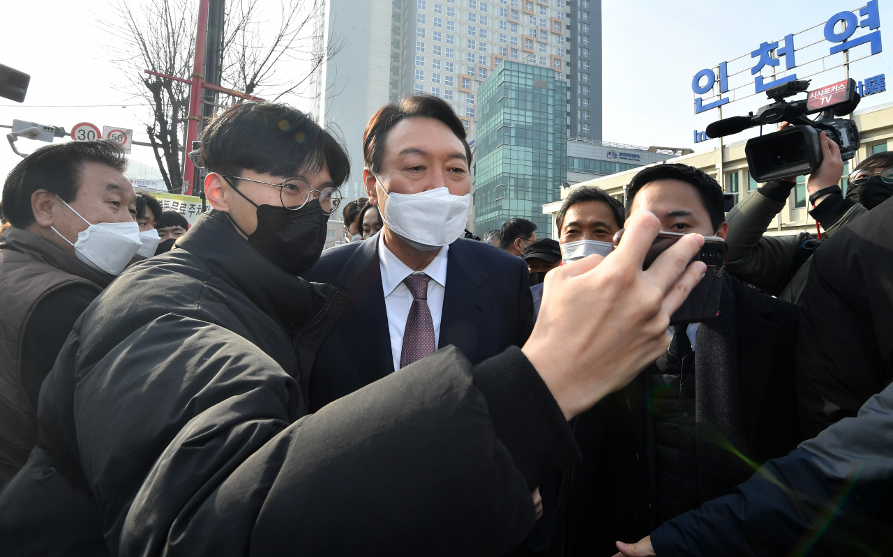 윤석열 국민의힘 대선 후보가 10일 오전 인천역 앞 광장에서 산업화·교역일번지 인천지역 공약 발표를 마치고 한 시민과 셀카 촬영에 응하고 있다. [연합]