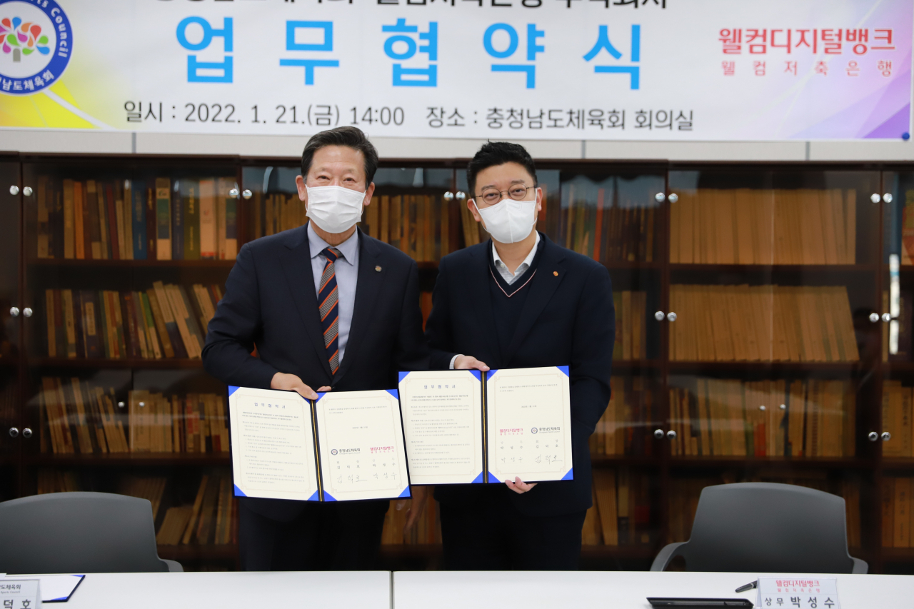 김덕호 충청남도체육회 회장(사진 왼쪽)과 박성수 웰컴저축은행 상무이사가 21일 충청남도체육회 회의실에서 진행된 업무협약식에서 기념촬영을 하고 있다.[웰컴저축은행 제공]