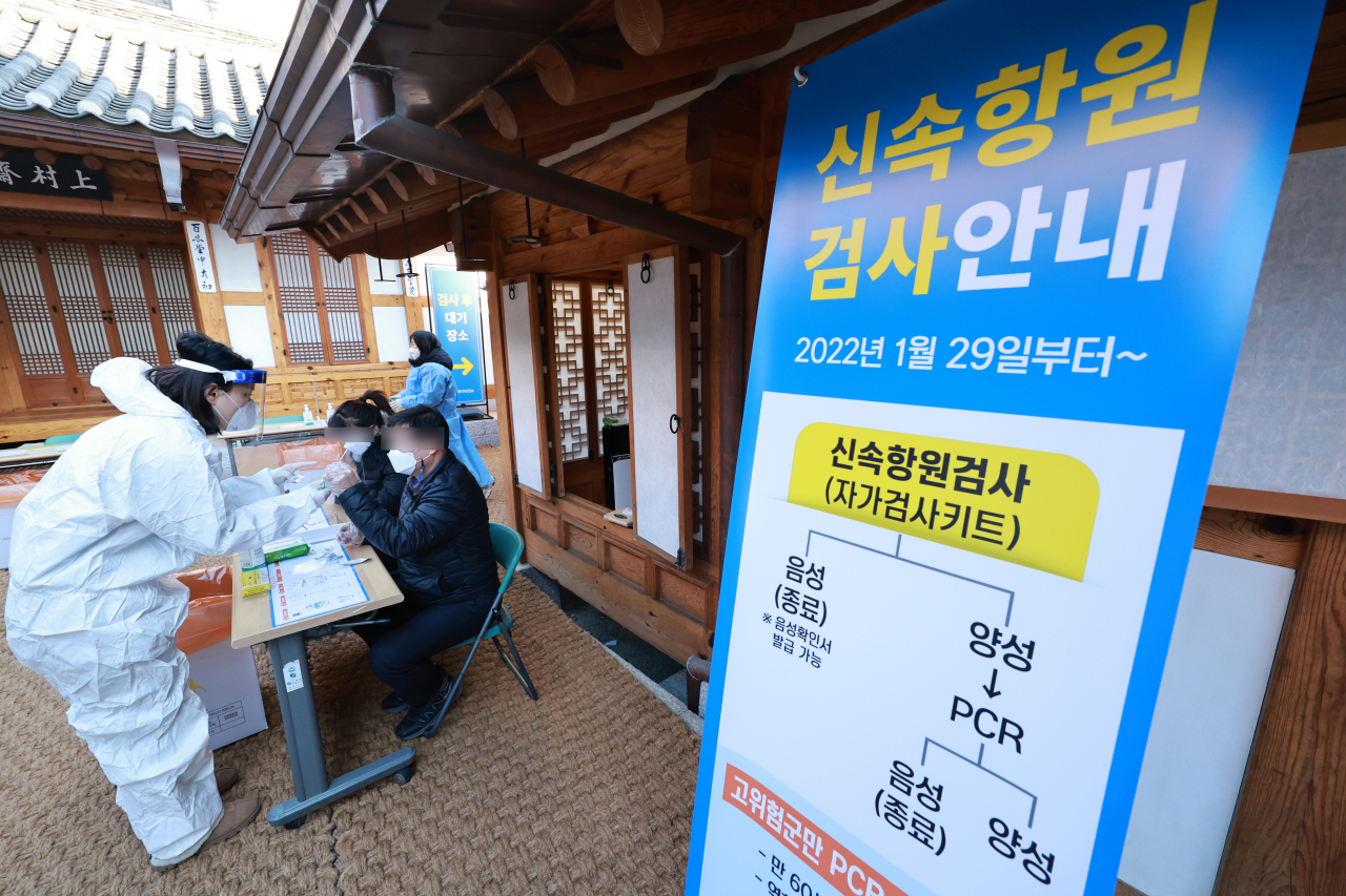 29일 서울 종로구 보건소 코로나19 선별검사소를 찾은 시민들이 자가검사 키트로 신속항원 검사를 하고 있다. 검사소에서 자가검사를 마친 시민들은 검사소에 마련된 별도 공간에서 검사키트에 양성 또는 음성 여부가 확인될 때까지 15분간 대기해야 한다. 검사에서 양성이 나올 경우 바로 옆 PCR검사 장소로 이동해 PCR 검사를 받는다. 음성이 나올 경우 키트를 폐기 장소에 버린 뒤 필요에 따라 방역패스를 위한 음성확인서를 발급받아 귀가하면 된다. [연합]
