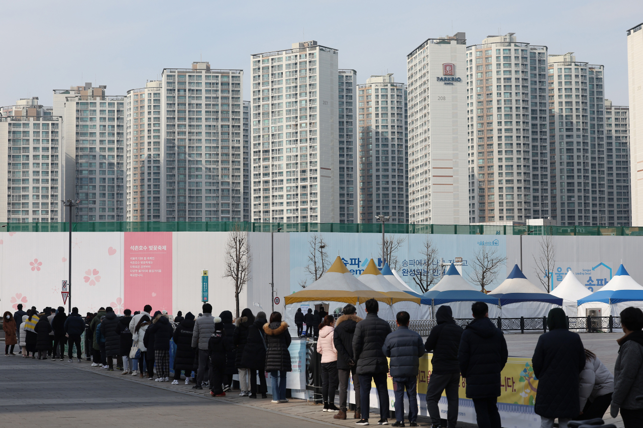 31일 올림픽공원 평화의문 앞에 마련된 코로나19 임시 선별검사소에 시민들이 줄을 서서 검사를 기다리고 있다. 중앙방역대책본부는 이날 0시 기준으로 확진자가 1만7085명 늘어 누적 84만5709명이라고 밝혔다. 오미크론 변이 바이러스에 감염된 것으로 판정된 신규 확진자는 일주일간 7019명 늘었다. [연합]