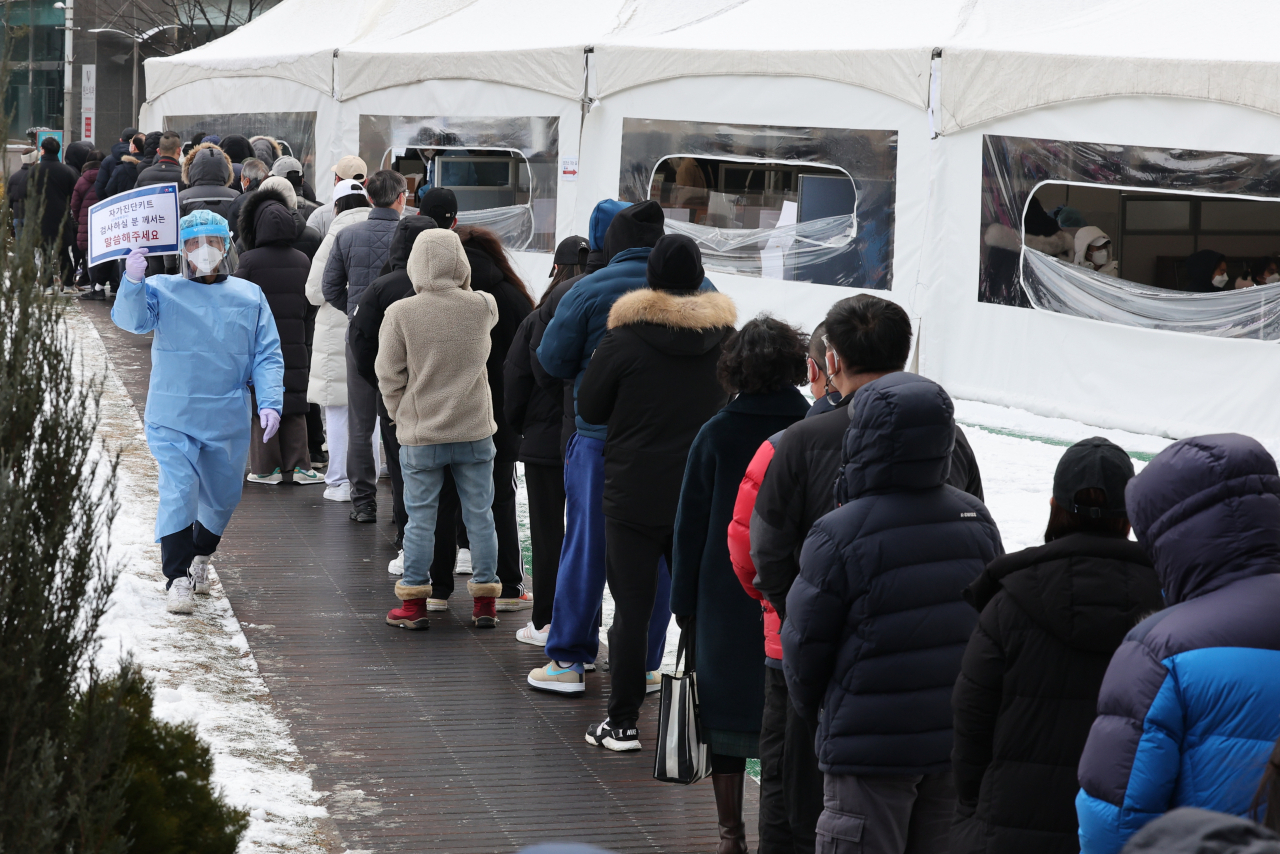 설 연휴에 코로나19 오미크론 변이가 급속히 확산하면서 신규 확진자 수가 역대 최다인 1만8000명대를 기록한 1일 설날 아침 서울 송파구보건소에 마련된 선별검사소에서 시민들이 줄을 서서 검사 순서를 기다리고 있다. [연합]