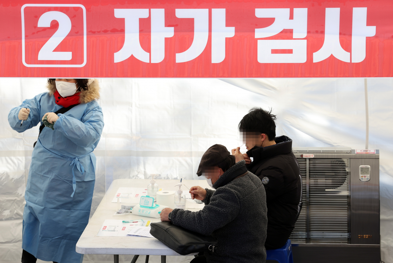 선별진료소에 마련된 신속항원검사소에서 시민들이 자가진단키트를 이용해 검사를 하고 있다. 연합뉴스