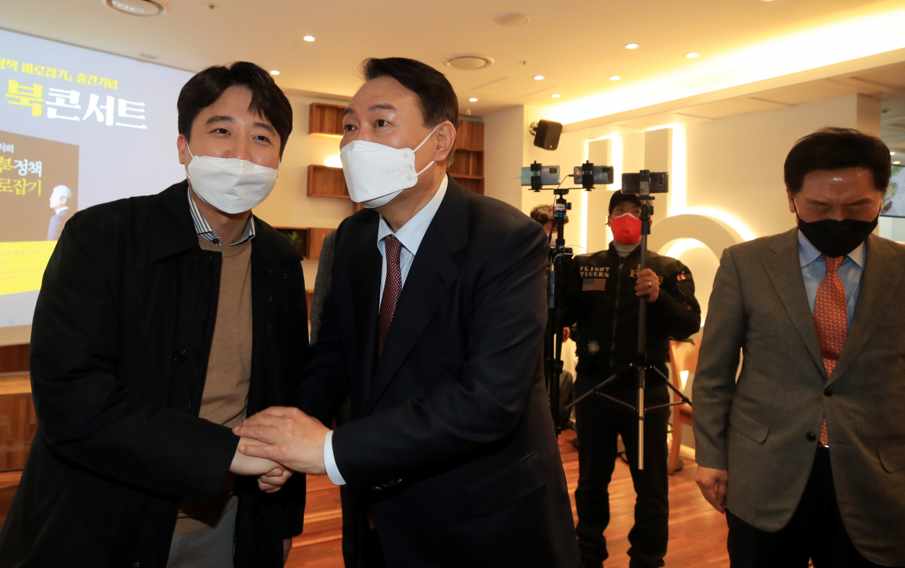윤석열 국민의힘 대선 후보와 이준석 대표가 9일 오후 서울 여의도 한 카페에서 열린 김근식 교수의 대북정책 관련 북콘서트에 참석, 기념 촬영을 한 뒤 악수하고 있다. [연합]