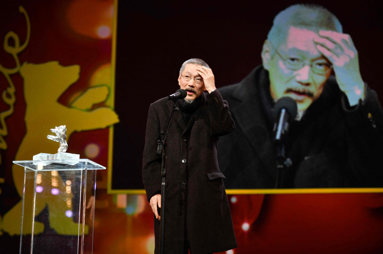 South Korean director and screenwriter Hong Sang-soo poses with the Silver Bear for Grand Jury for the film 'So-seol-ga-ui Yeong-hwa' (The Novelist) during the awards ceremony of the 72nd Berlinale Film Festival in Berlin on Wednesday. (Photo by Stefanie LOOS / AFP)
