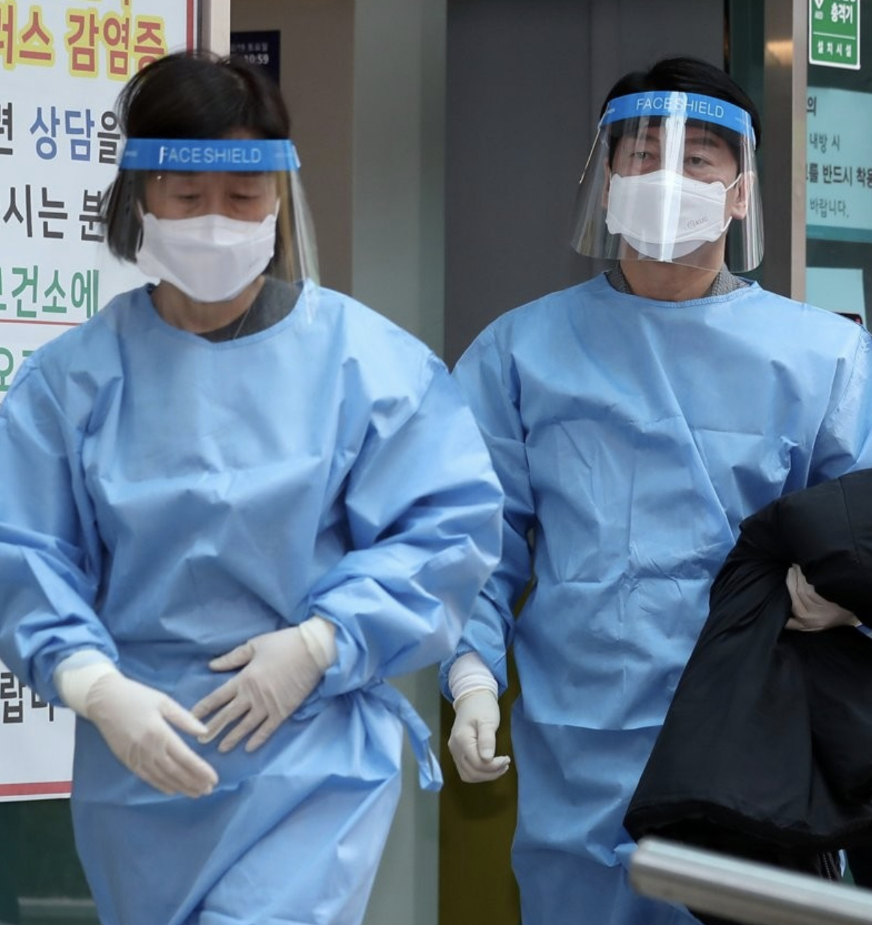 안철수 국민의당 대선 후보와 부인 김미경 교수가 19일 서울 중구보건소 선별진료소에서 방역복을 착용하고 진료소로 향하고 있다. [연합]