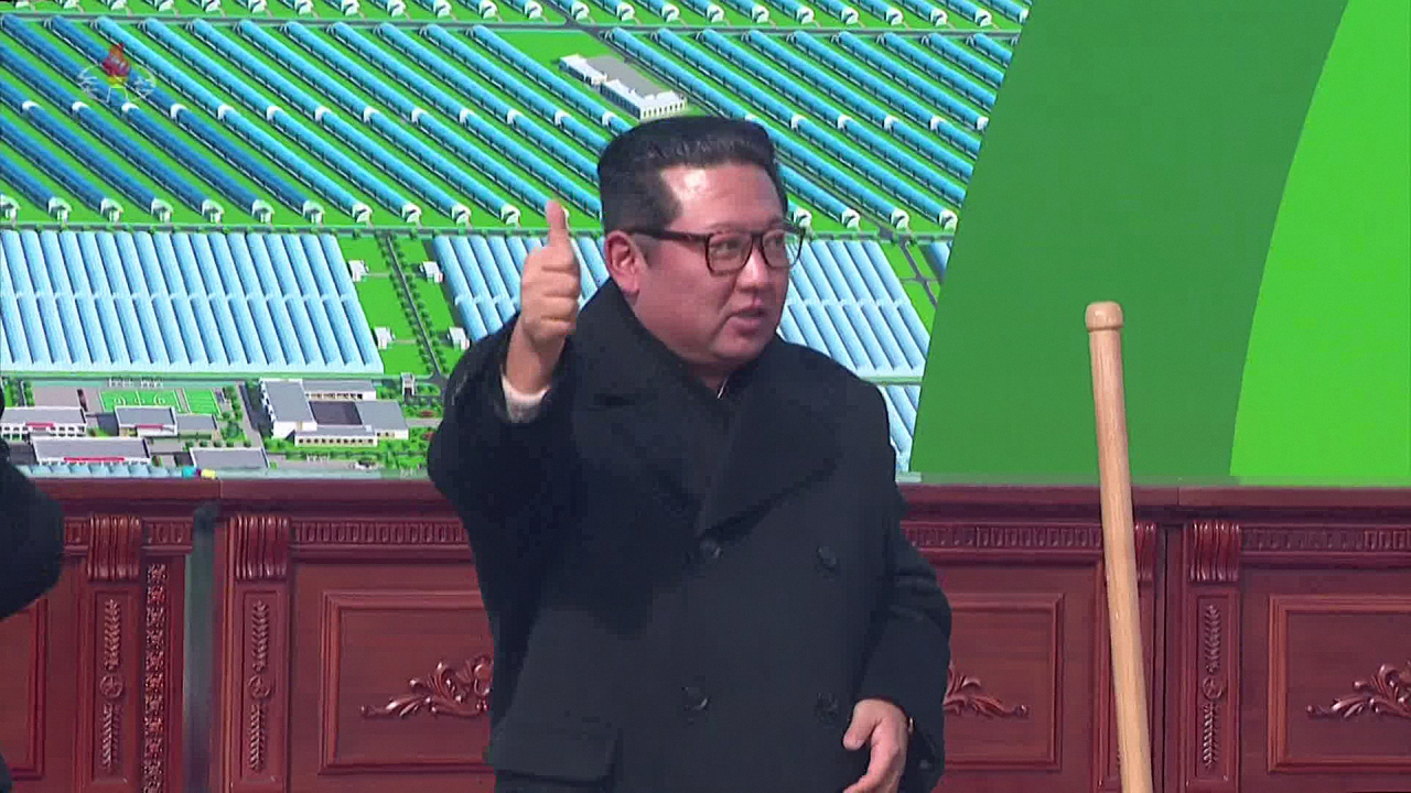 This photo captured from North Korea's official Korean Central Television on Saturday, shows leader Kim Jong-un giving a thumbs-up sign during a groundbreaking ceremony for the construction of a greenhouse farm in the eastern province of South Hamgyong the previous day. (Yonhap)