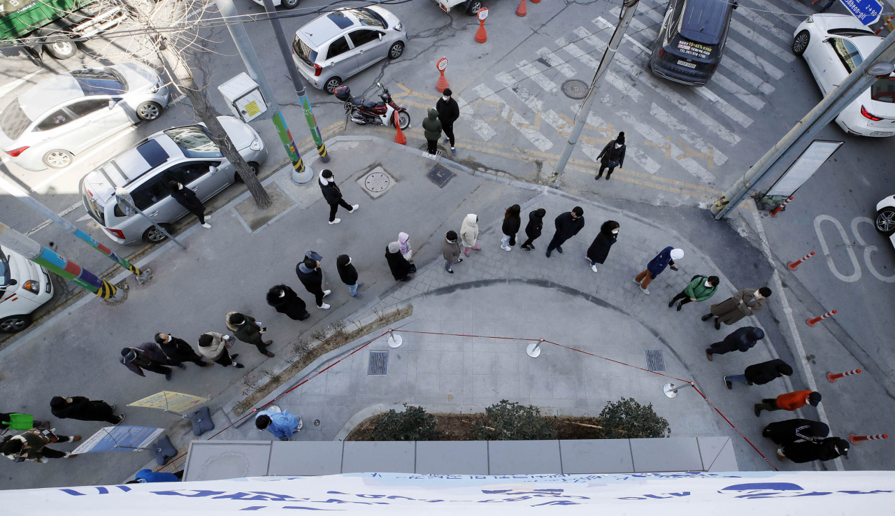 People wait in line to receive tests at a COVID-19 testing station in the southwestern city of Gwangju yesterday, in this photo provided by a local government. (local government)