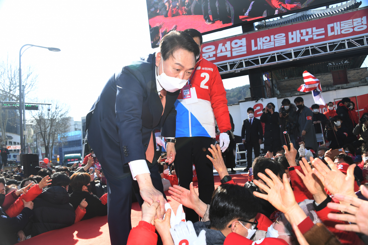 윤석열 국민의힘 대선후보가 24일 오후 경기도 수원시 팔달문 앞에서 열린 집중 유세에서 연설을 마친 후 지지자들과 악수하고 있다. [연합]