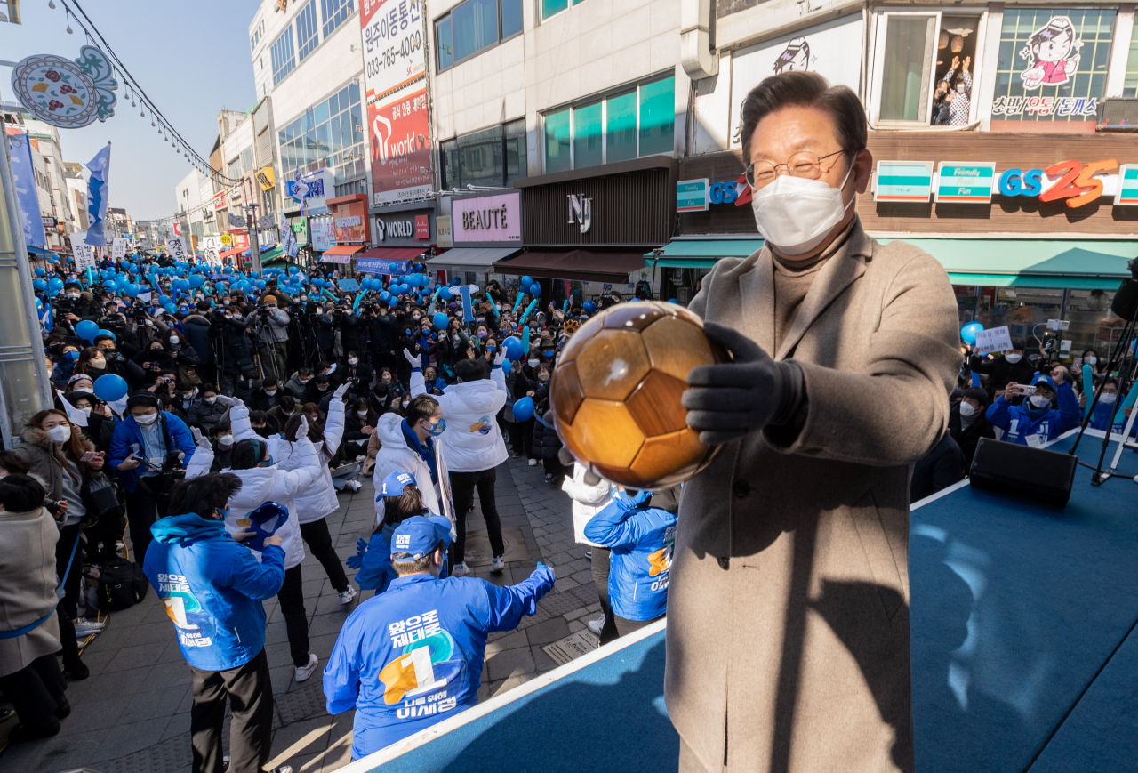 이재명 더불어민주당 대선후보가 24일 오후 강원도 원주 중앙로 문화의거리 유세에서 선물 받은 백두산 고목으로 만들어진 축구공을 선물 받고 있다. [연합]