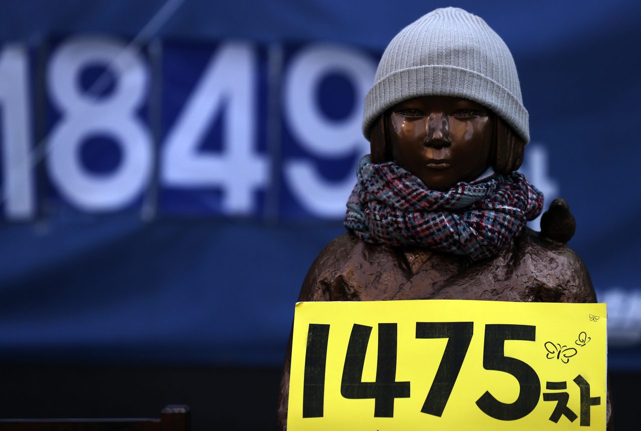 A statue symbolyzing victims of Japan's wartime sexual slavery in front of the Japanese Embassy in Seoul. (Yonhap)