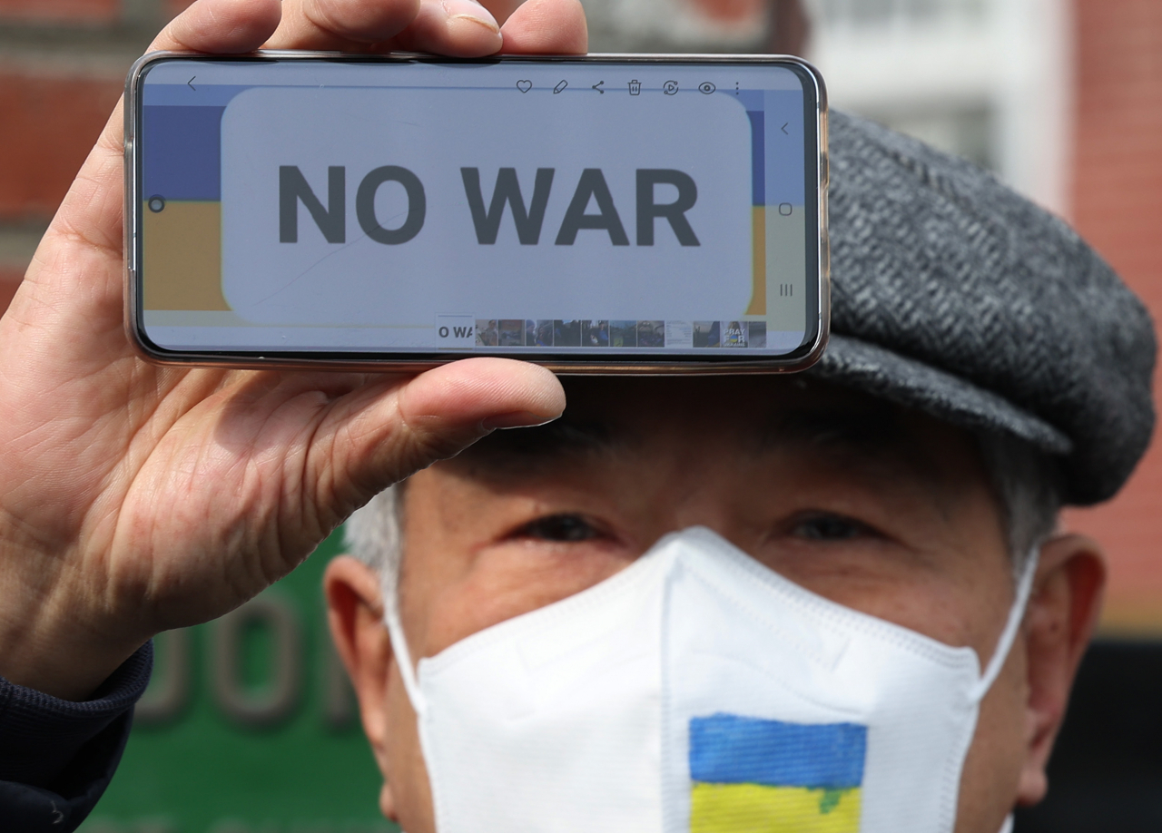 A South Korean protests Russia for its invasion of Ukraine in front of the Russian Embassy in Seoul on Monday. (Yonhap)