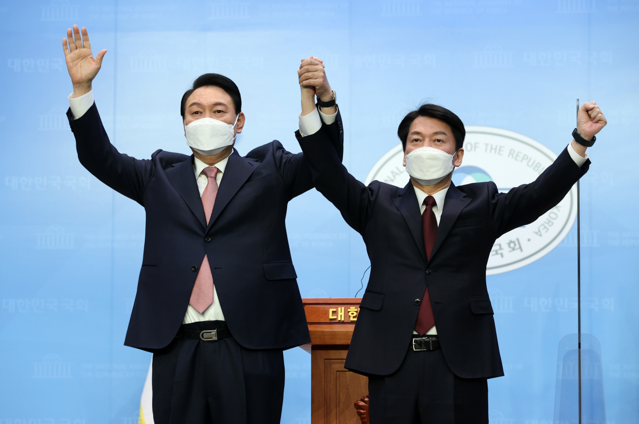 윤석열 국민의힘 대선 후보와 안철수 국민의당 대선 후보가 3일 오전 국회 소통관에서 단일화 기자회견을 마치며 포즈를 취하고 있다. [연합]
