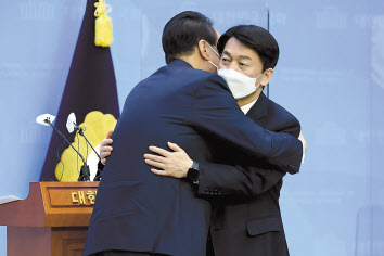 윤석열 국민의힘 대선후보와 안철수 국민의당 대선 후보가 3일 오전 국회 소통관에서 단일화 기자회견을 마치고 포옹하고 있다.[국회사진기자단]