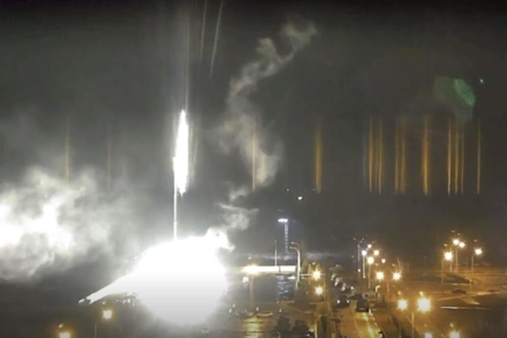 This image made from a video released by Zaporizhzhia nuclear power plant shows bright flaring object landing in grounds of the nuclear plant in Enerhodar, Ukraine on Friday. Russian forces shelled Europe’s largest nuclear plant early Friday, sparking a fire as they pressed their attack on a crucial energy-producing Ukrainian city and gained ground in their bid to cut off the country from the sea. (Zaporizhzhia nuclear power plant via AP)