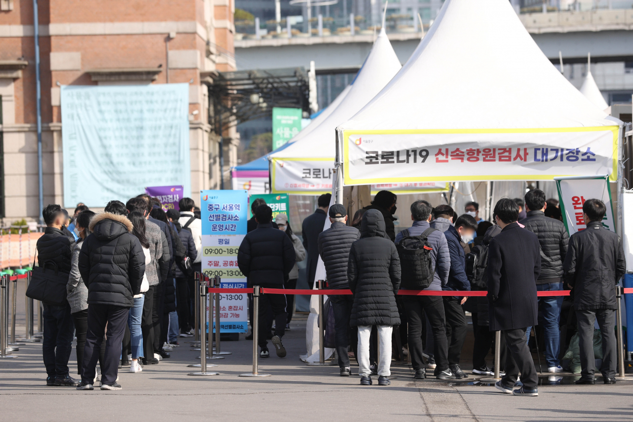 21일 오전 서울역 선별진료소에서 시민들이 신속항원검사 결과를 기다리고 있다. 중앙방역대책본부는 21일 0시 기준 코로나19 신규 확진자가 20만9169명 집계됐다고 밝혔다. [연합]