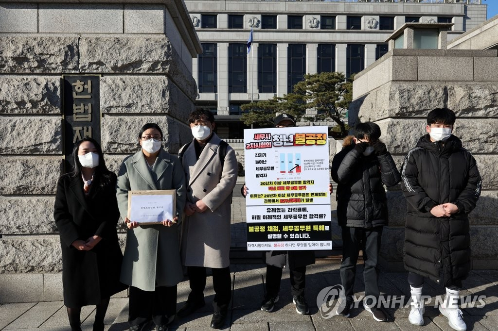 지난 1월 17일 오전 서울 헌법재판소 앞에서 세무사시험제도개선연대 관계자 등이 세무사 자격시험이 세무공무원 출신 응시자에게 절대적으로 유리해 일반 응시자가 큰 피해를 봤다는 내용의 헌법소원 심판 청구서를 들고 있다. [연합]