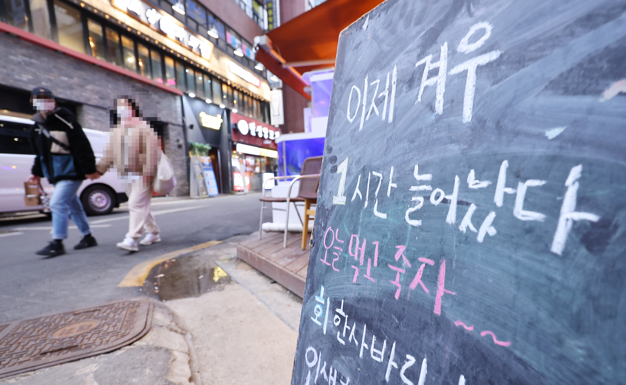지난 4일 오후 서울 종로구의 한 식당 앞에 방역지침을 비판하는 간판이 세워져 있다. [연합]
