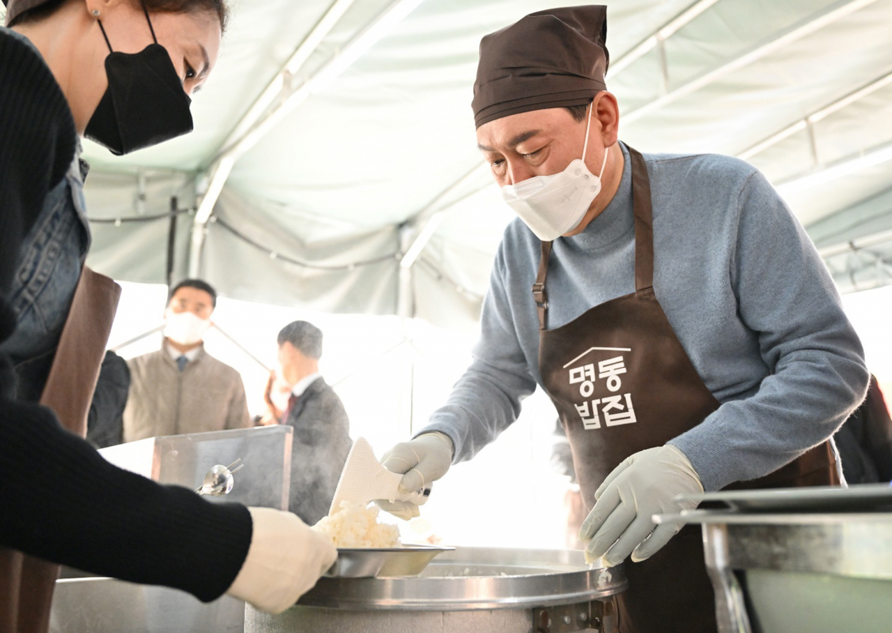 윤석열 대통령 당선인이 30일 서울 명동성당 내 무료 급식소인 명동밥집을 찾아 배식 봉사활동을 하고 있다. [연합]