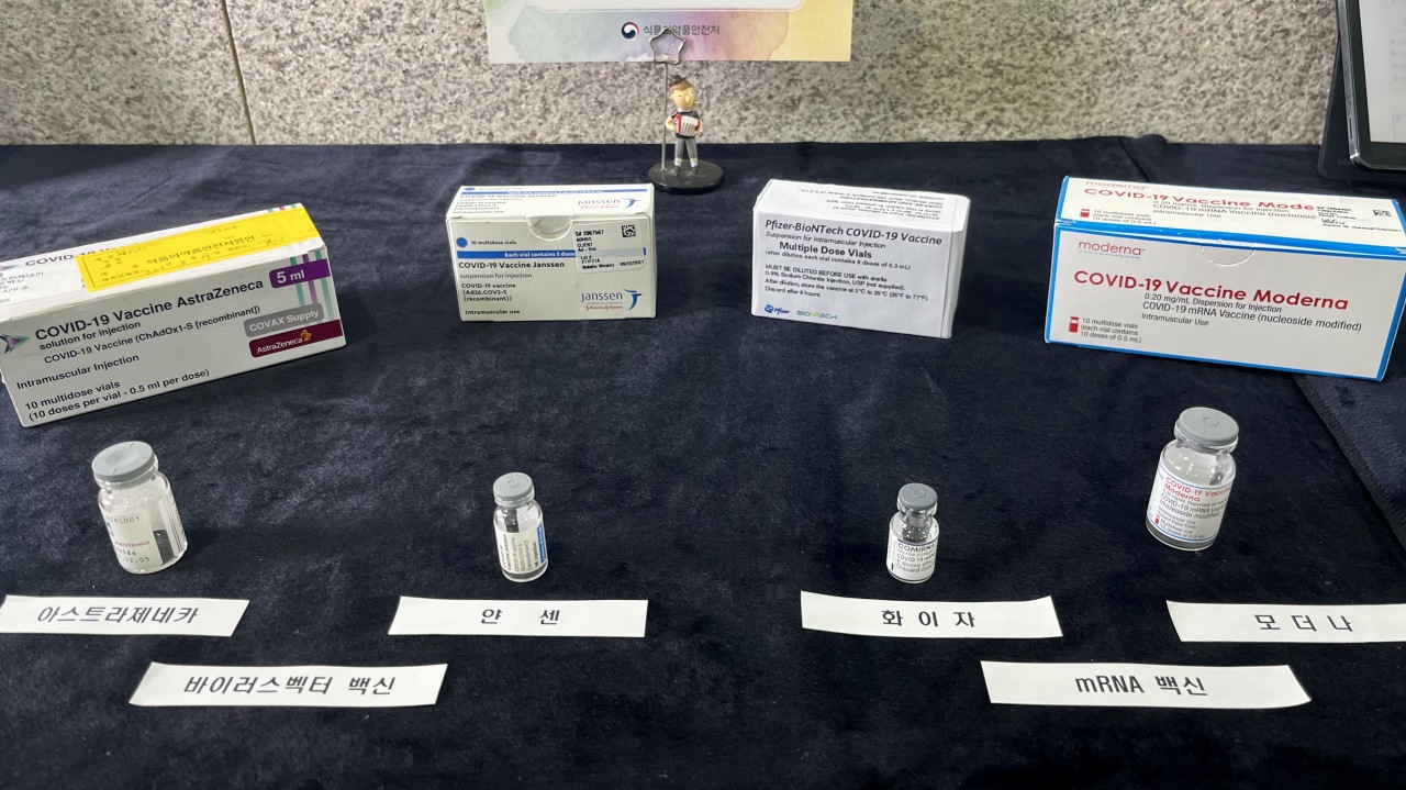 Vials of four different brands of COVID-19 vaccines approved for use in Korea are displayed on the table. (Kim Arin/The Korea Herald)