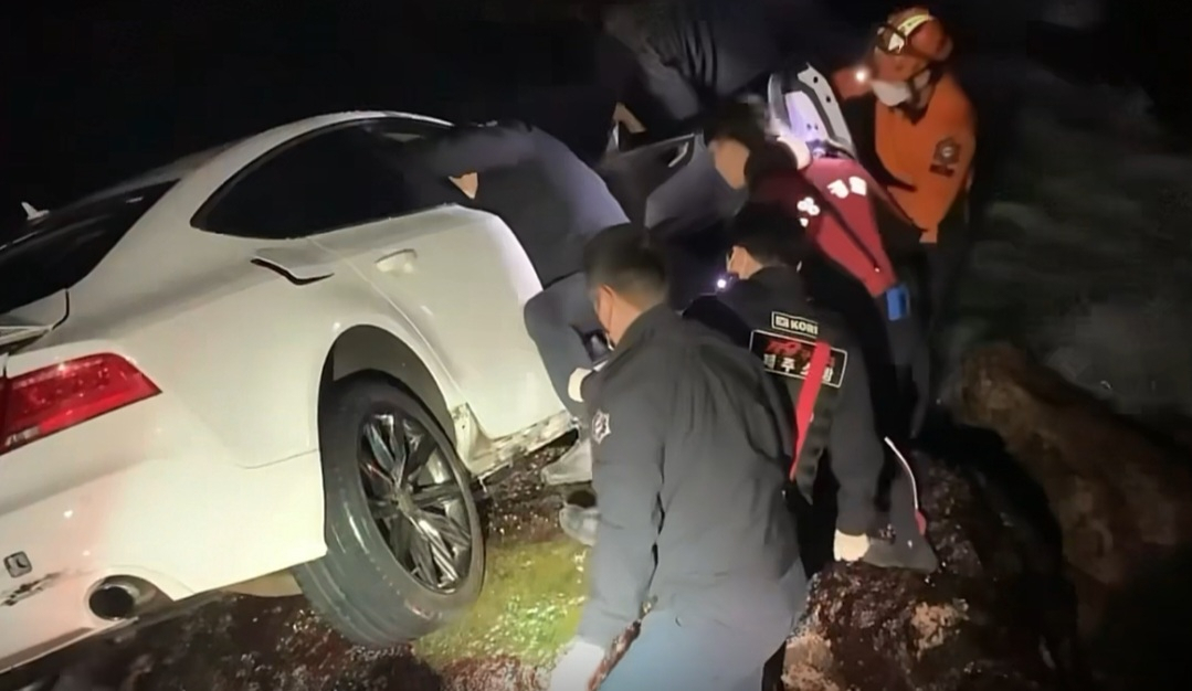 지난달 19일 제주시 애월읍 고내리 해안도로 절벽 아래 바다로 떨어져 유실됐던 아우디 차량을 경찰과 소방 구조대원들이 인양하고 있다. [제주서부경찰서 제공]
