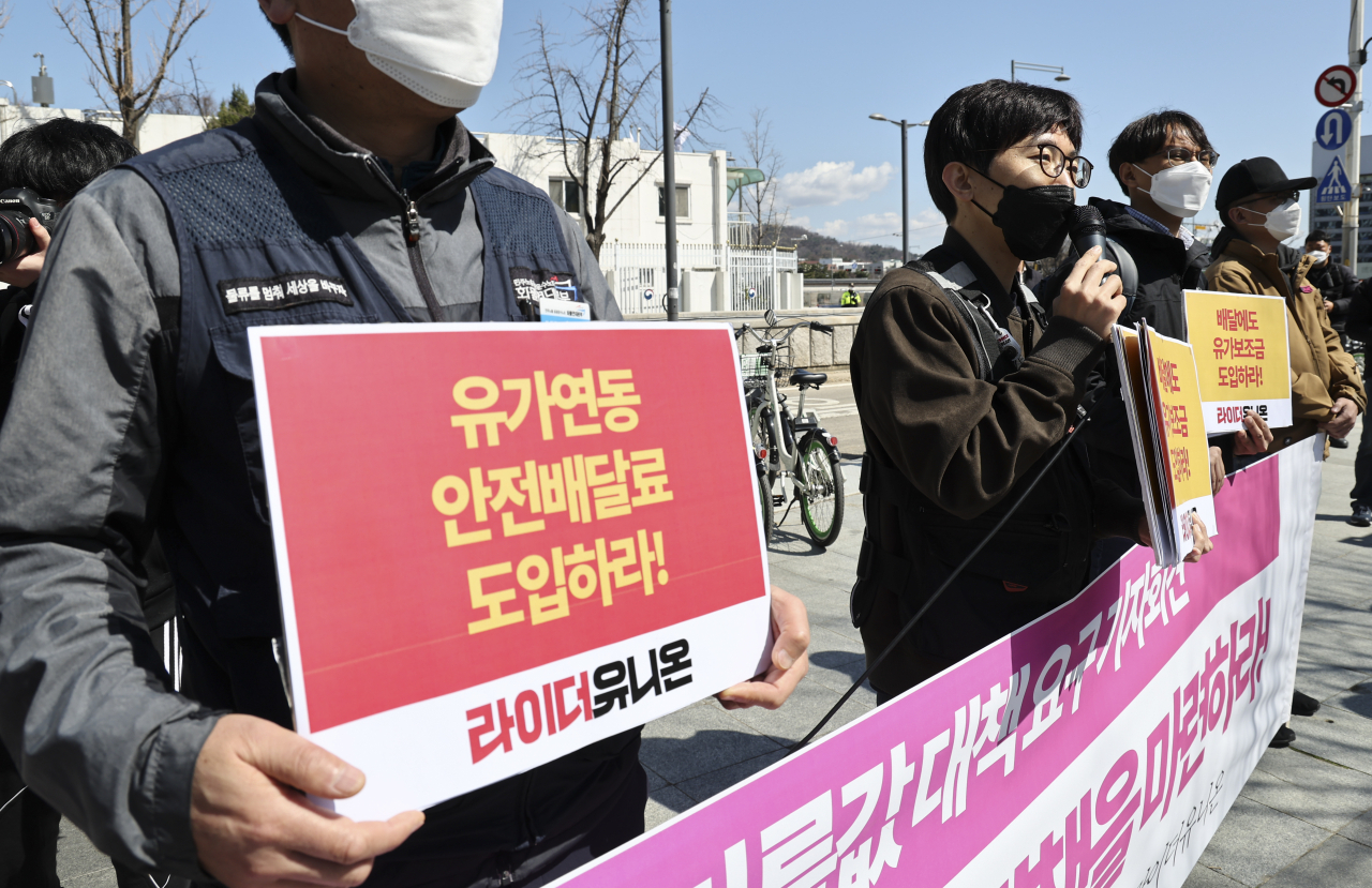 라이더유니온 소속 회원들이 1일 오전 정부서울청사 앞에서 열린 ‘기름값 대책 요구 기자회견’에서 관련 손피켓을 들고 있다. [연합]