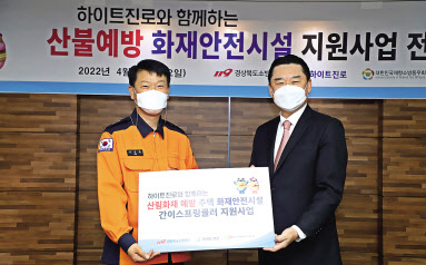 이영팔(왼쪽) 경북소방본부장과 하이트진로 김인규 대표가 ‘산림화재 주택 화재안전시설 간이스프링쿨러 지원사업’협약을 맺고 기념사진을 찍고 있다. [하이트진로 제공]