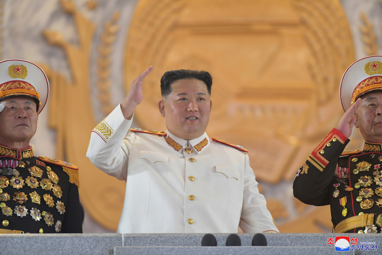 North Korean leader Kim Jong-un (C) waves during a military parade at Kim Il-sung Square in Pyongyang on Monday to mark the 90th anniversary of the founding of its army, in this photo released the next day by the North's official Korean Central News Agency. (Yonhap)