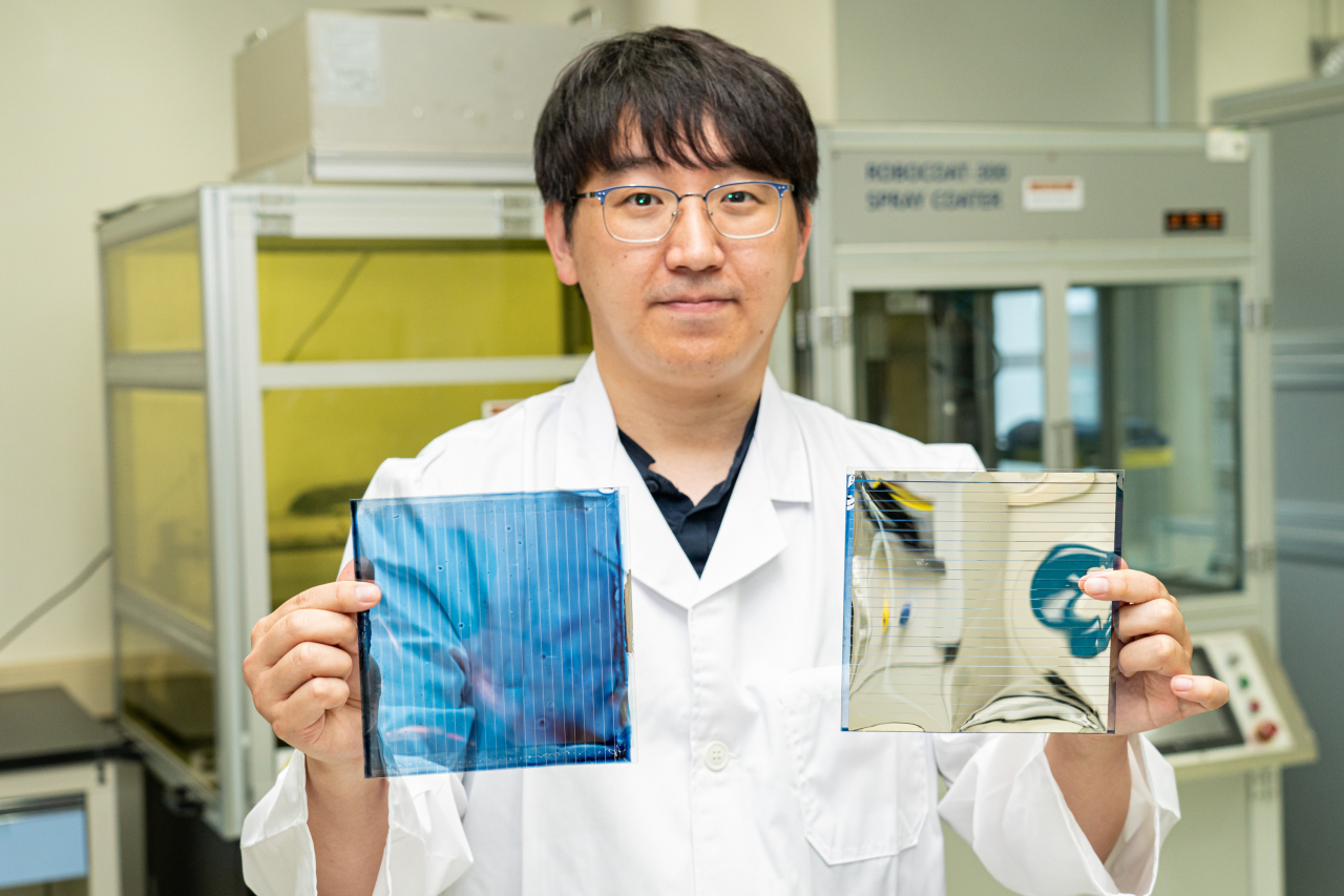 강홍규 박사가 투명(왼쪽)과 불투명 유기 태양전지 필름을 들어보이고 있다.[광주과기원 제공]