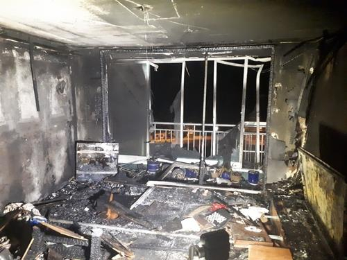 This photo, provided by the fire authority of Busan, about 450 kilometers southeast of Seoul, shows the inside of an apartment that was destroyed in a fire on Tuesday. (Yonhap)
