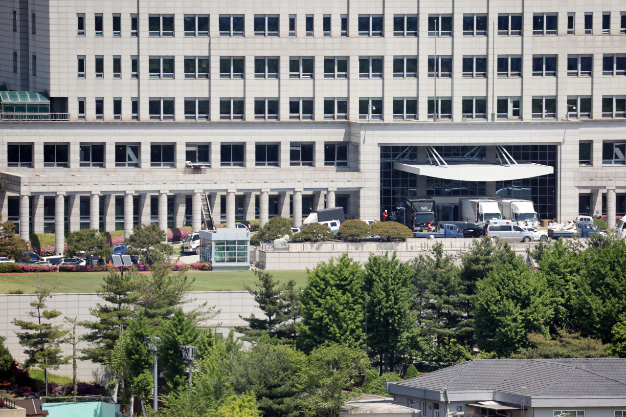 Moving trucks are parked at the defense ministry building in Seoul on Thursday, as the ministry wraps up relocation work to empty its main building, which will be used as the country's new presidential office. President-elect Yoon Suk-yeol has decided to move the presidential office to the compound from Cheong Wa Dae in the northern part of the capital. (Yonhap)