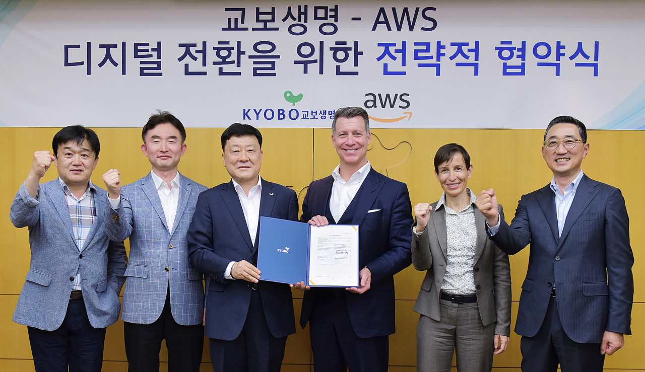 [사진=9일 오후 서울 광화문 교보생명 본사에서 열린 교보생명과 아마존웹서비스(AWS)의 디지털 전환을 위한 전략적 협약식에서 양사의 관계자들이 기념촬영을 하고 있다. 사진 왼쪽부터 교보생명 정봉현 IT지원담당 상무, 문성진 디지털테크놀로지담당 상무, 편정범 대표이사 사장, AWS 필 데이비스(Phil Davis) 아시아태평양 및 일본(APJ) 대표, 로렌스 티어리(Laurence Thiery) APJ 금융부문 사업 개발 담당, 함기호 AWS-코리아 대표.]